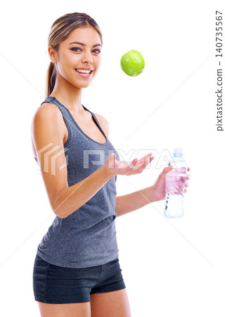 Happy woman, portrait and fitness with apple or water in natural sustainability or diet on a white studio background. Active female person or athlete with smile, green organic fruit and mineral drink 140735567