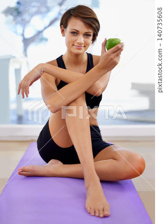 Portrait, fitness and woman with apple on yoga mat in gym for diet, wellness or weight loss with healthy body. Nutrition, floor and person eating fruit or organic food with vitamin c after exercise Portrait, fitness and woman with apple on yoga mat in gym for diet, wellness or weight loss with healthy body. Nutrition, floor and person eating fruit or organic food with vitamin c after exercise 140735608