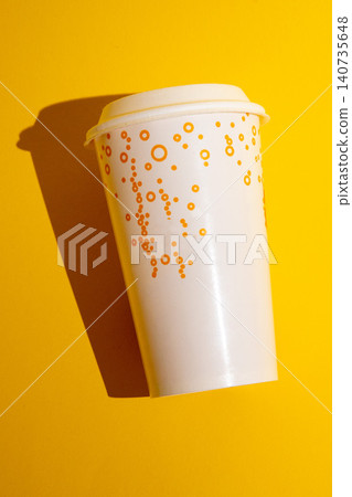 White Disposable Paper Coffee Cup With Lid Casting Shadow, Isolated On Bright Yellow Background 140735648