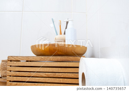 Bathroom Essentials on Wooden Tray. Dental Care and Hygiene Set with Toothbrushes and Soap on Eco Friendly background Bathroom Essentials on Wooden Tray. Dental Care and Hygiene Set with Toothbrushes and Soap on Eco Friendly background 140735657