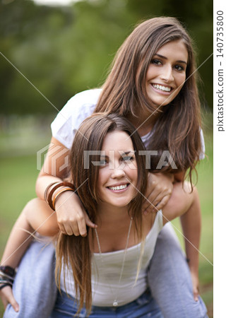Portrait, smile and couple of friends with piggyback ride for bonding, adventure and summer vacation in outdoor. Happy, relax and woman carrying lady for fresh air, support and park together Portrait, smile and couple of friends with piggyback ride for bonding, adventure and summer vacation in outdoor. Happy, relax and woman carrying lady for fresh air, support and park together 140735800