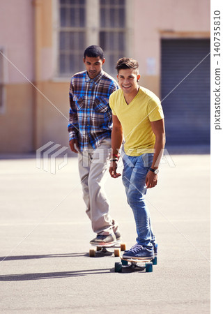 Skateboard, friends and men in street for exercise, training and competition for fun hobby in city. Skate park, fashion and young people in trendy, casual outfit and style for sports and fitness Skateboard, friends and men in street for exercise, training and competition for fun hobby in city. Skate park, fashion and young people in trendy, casual outfit and style for sports and fitness 140735810