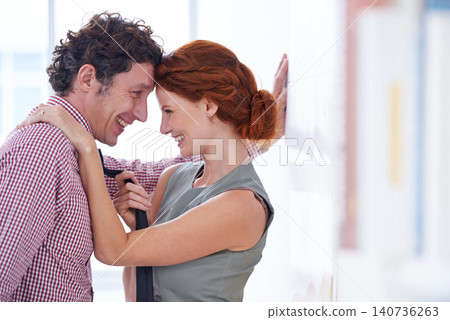 Couple, love and office romance with bonding, secret and happy staff at a company with a smile. Business people, workplace and flirt at a startup with employees together with embrace in relationship Couple, love and office romance with bonding, secret and happy staff at a company with a smile. Business people, workplace and flirt at a startup with employees together with embrace in relationship 140736263