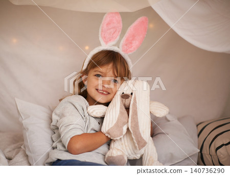 Girl, kid and bunny ears with teddy bear, soft toys and playing in fort for camping and fun at family home. Happiness, innocent and child with stuffed animal, games for Easter and fun in childhood Girl, kid and bunny ears with teddy bear, soft toys and playing in fort for camping and fun at family home. Happiness, innocent and child with stuffed animal, games for Easter and fun in childhood 140736290