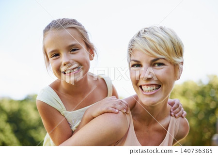 Piggyback, portrait and mom with kid to play outdoors for bonding, love and happiness in garden for mothers day. Mother, daughter and together with care for summer fun in backyard with shoulder game Piggyback, portrait and mom with kid to play outdoors for bonding, love and happiness in garden for mothers day. Mother, daughter and together with care for summer fun in backyard with shoulder game 140736385