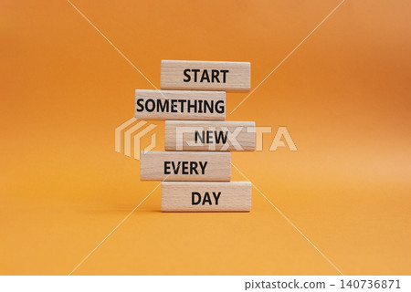 New symbol. Wooden blocks with words Start Something New Every Day. Beautiful orange background. Business and New concept. Copy space 140736871