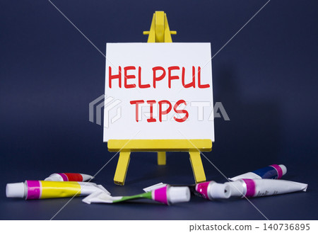 Helpful tips symbol. Wooden blocks with words Helpful tips. Beautiful deep blue background with paints and easel. Business and Helpful tips concept. Copy space. Helpful tips symbol. Wooden blocks with words Helpful tips. Beautiful deep blue background with paints and easel. Business and Helpful tips concept. Copy space. 140736895