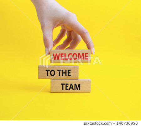 Team symbol. Wooden blocks with words Welcome to the Team. Businessman hand. Beautiful yellow background. Business and Welcome to the Team concept. Copy space. Team symbol. Wooden blocks with words Welcome to the Team. Businessman hand. Beautiful yellow background. Business and Welcome to the Team concept. Copy space. 140736950