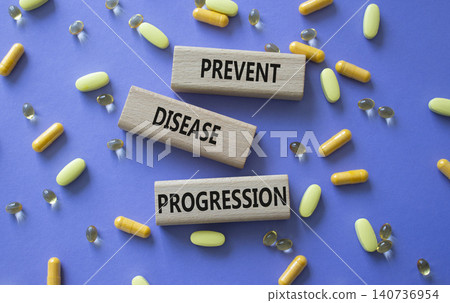Prevent Disease Progression symbol. Concept words Prevent Disease Progression on wooden blocks. Beautiful purple background with pills. Healthcare and Prevent Disease Progression concept. Copy space. Prevent Disease Progression symbol. Concept words Prevent Disease Progression on wooden blocks. Beautiful purple background with pills. Healthcare and Prevent Disease Progression concept. Copy space. 140736954