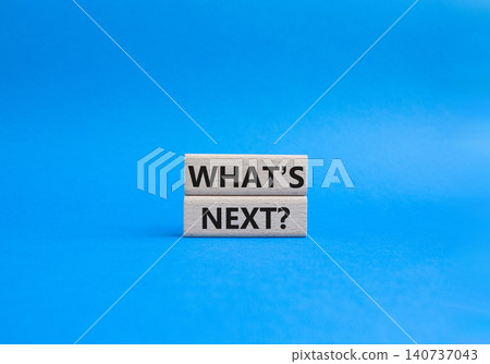 What is next symbol. Concept words What is next on wooden blocks. Beautiful blue background. Business and What is next concept. Copy space. 140737043