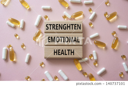 Strengthen emotional health symbol. Concept words Strengthen emotional health on wooden blocks. Beautiful pink background with pills. Healthcare and Strengthen emotional health concept. Copy space. Strengthen emotional health symbol. Concept words Strengthen emotional health on wooden blocks. Beautiful pink background with pills. Healthcare and Strengthen emotional health concept. Copy space. 140737101