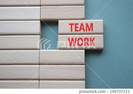 TEAM WORK symbol. Concept word TEAM WORK on wooden blocks. Beautiful grey green background. Business and TEAM WORK concept. Copy space 140737151