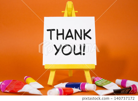 Thank you symbol. Wooden blocks with words Thank you. Beautiful orange background with paints and easel. Business and Thank you concept. Copy space. Thank you symbol. Wooden blocks with words Thank you. Beautiful orange background with paints and easel. Business and Thank you concept. Copy space. 140737172