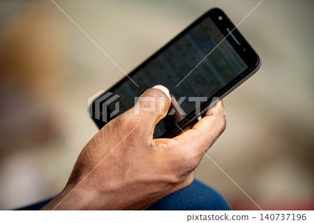 male hand using a mobile phone male hand using a mobile phone 140737196