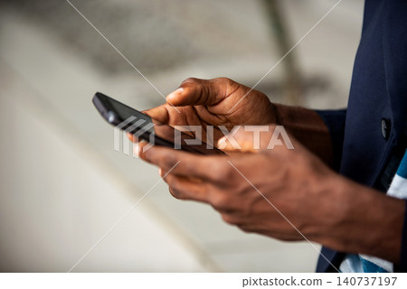 adult man's hand using a mobile phone adult man's hand using a mobile phone 140737197