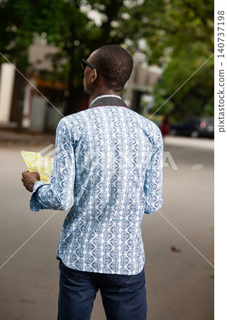 young tourist man holding a map of the city 140737198
