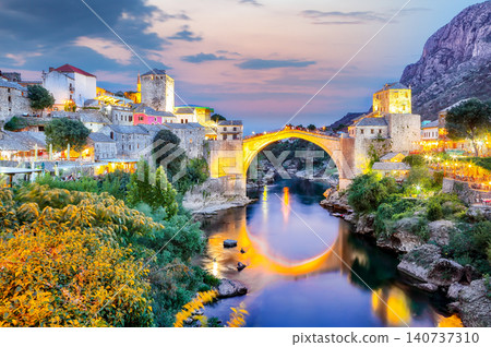 Amazing Skyline of Mostar with the Mostar Bridge, houses and minarets, at sunset. Amazing Skyline of Mostar with the Mostar Bridge, houses and minarets, at sunset. 140737310