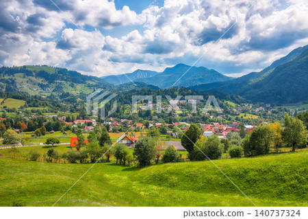 Amazing alpine landscape with green fields and Piatra Craiului mountains in Dambovicioara Commune. Amazing alpine landscape with green fields and Piatra Craiului mountains in Dambovicioara Commune. 140737324