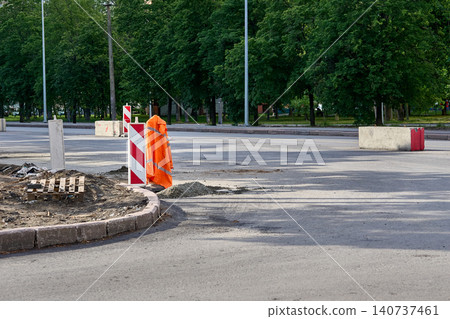 Road construction site.Safety sign,with hanging orange uniform jacket Road construction site.Safety sign,with hanging orange uniform jacket 140737461