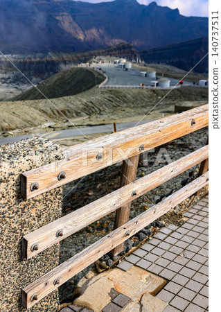 Wooden railing made from Japanese Cypress along the walkway near the volcanic crater. Aso Volcano, Japan. Wooden railing made from Japanese Cypress along the walkway near the volcanic crater. Aso Volcano, Japan. 140737511