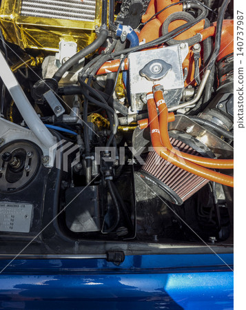 TAVERNES BLANQUES, SPAIN - JUNE 14, 2026.A blue Subaru Impreza WRX STi is parked at a retro car exhibition in Spain. The hood is open, allowing visitors to view the engine and internal components of t 140737987