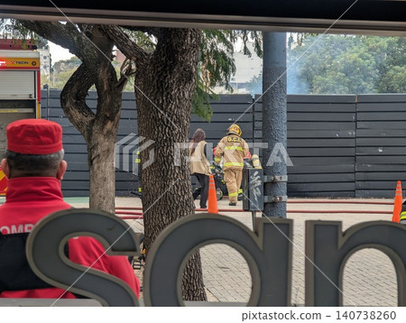 Cordoba, Argentina - June 24, 2026: Firefighters work near safety cones during a training drill 140738260