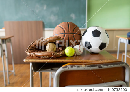 Sports equipment placed on a school desk 140738300