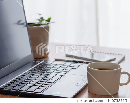 A simple workspace with coffee and a laptop. A simple workspace with coffee and a laptop. 140738715