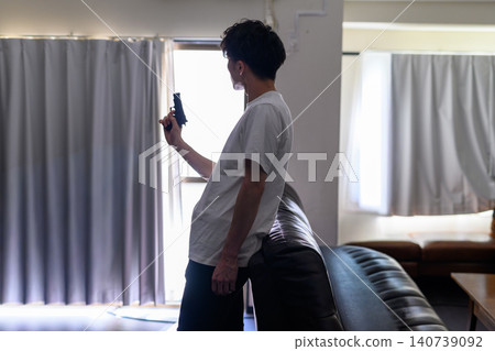The man raises his gun. The man raises his gun. 140739092