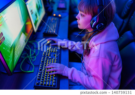 Female gamer using a keyboard Female gamer using a keyboard 140739131