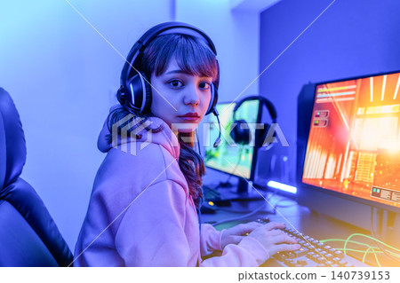 A woman playing a game in blue light A woman playing a game in blue light 140739153
