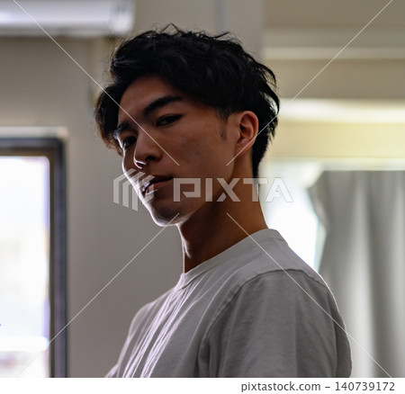 A man staring at me from inside the room. A man staring at me from inside the room. 140739172