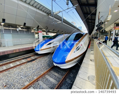 A platform where Shinkansen E7 and W7 series trains are lined up. A platform where Shinkansen E7 and W7 series trains are lined up. 140739493