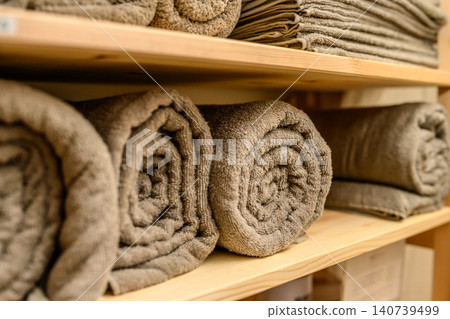 Clean towels neatly arranged on a wooden shelf. Clean towels neatly arranged on a wooden shelf. 140739499