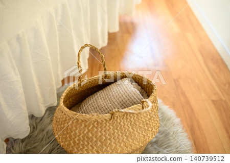 A blanket in a rattan basket A blanket in a rattan basket 140739512
