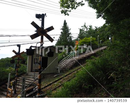 A retro railway line winds up a steep slope. A snapshot of a nostalgic station building that intersects with the Ikoma Mountain hiking trail. A retro railway line winds up a steep slope. A snapshot of a nostalgic station building that intersects with the Ikoma Mountain hiking trail. 140739539