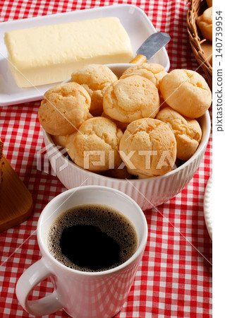 Golden cheese bread served with butter and hot coffee, representing the authentic flavors of Brazilian cuisine Golden cheese bread served with butter and hot coffee, representing the authentic flavors of Brazilian cuisine 140739954