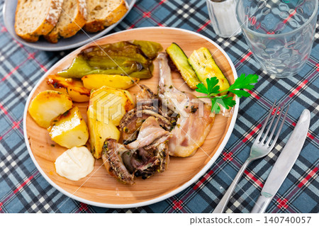 Roasted rabbit served with vegetable garnish Roasted rabbit served with vegetable garnish 140740057
