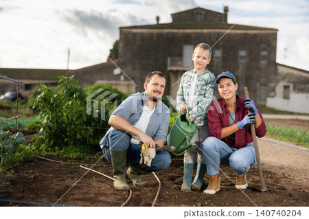 Family of farmers standing in the garden Family of farmers standing in the garden 140740204