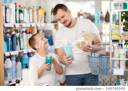 Schoolboy son and dad are choosing bast wisp and shower gel in store 140740349
