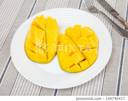 Deliciously served fresh mangoes diced and laid out on plate Deliciously served fresh mangoes diced and laid out on plate 140740417