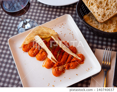 Savory sauce Muhammara of hot red pepper and walnuts with flatbread Savory sauce Muhammara of hot red pepper and walnuts with flatbread 140740637