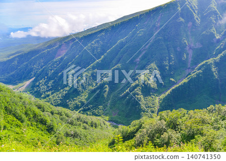 On a clear summer day, the magnificent cliffs of the Naso Valley can be seen below from the hiking trail of the Kisakata-guchi route to Mt. Chokai. On a clear summer day, the magnificent cliffs of the Naso Valley can be seen below from the hiking trail of the Kisakata-guchi route to Mt. Chokai. 140741350