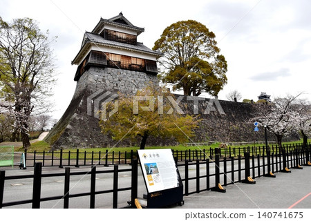 Kumamoto Prefecture: Kumamoto Castle's Hitsujisaru Turret, fresh greenery, cherry blossoms in full bloom, and a Kumamoto Castle tourist information sign. Kumamoto Prefecture: Kumamoto Castle's Hitsujisaru Turret, fresh greenery, cherry blossoms in full bloom, and a Kumamoto Castle tourist information sign. 140741675