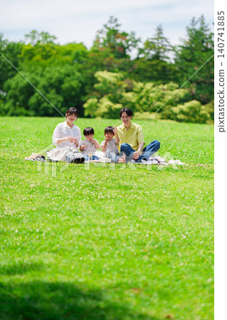 A family of four having a picnic on a sunny hill. A family of four having a picnic on a sunny hill. 140741885
