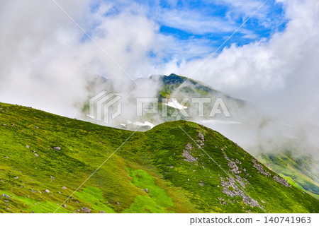 Summer at Mount Chokai: The summit of the highest peak emerges from the rising clouds. Summer at Mount Chokai: The summit of the highest peak emerges from the rising clouds. 140741963
