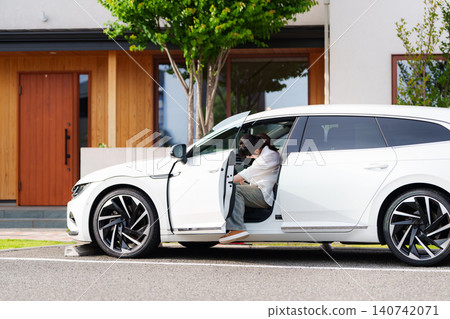 A couple gets into their car to go out. A couple gets into their car to go out. 140742071