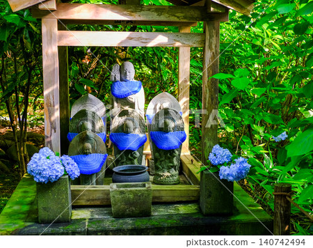 Blue hydrangeas and stone Buddha Blue hydrangeas and stone Buddha 140742494