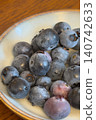 A refreshing image of early summer with ripe blueberries and a ceramic dish. 140742633