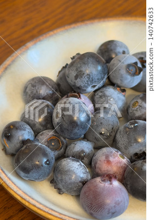 A refreshing image of early summer with ripe blueberries and a ceramic dish. A refreshing image of early summer with ripe blueberries and a ceramic dish. 140742633